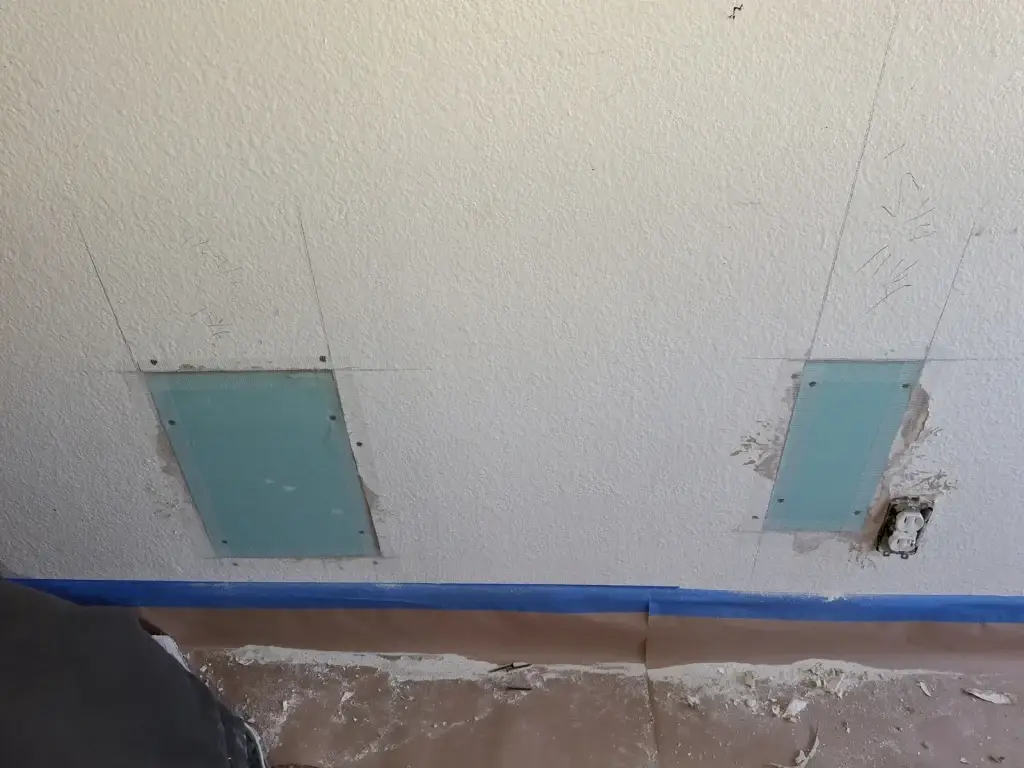 Drywall patches set into pet damaged wall