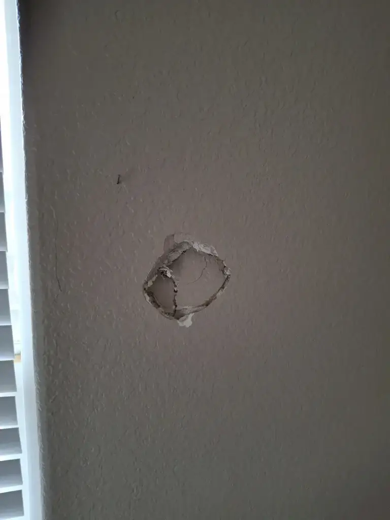 Fist-size hole in wall