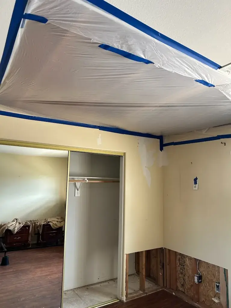 Flood cut drywall with plastic containment